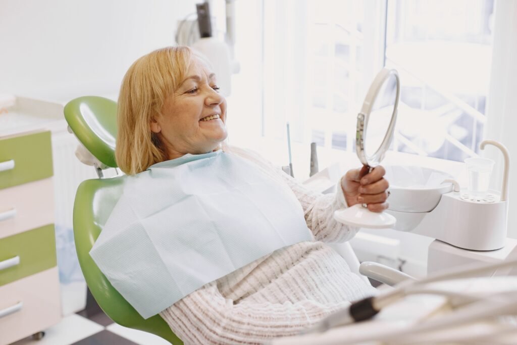 Older patient smiling confidently after a checkup at Serene Dental Spa in Weddington.